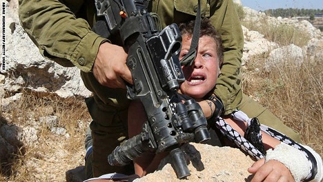 انتشار واسع لصورة جندي إسرائيلي يثبت رأس طفل فلسطيني..