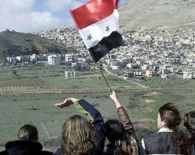 Group of Syrian citizens waving their flag while eyes on the occupied Golan Heights