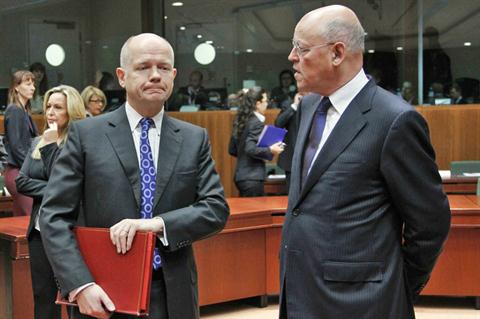 British Foreign Secretary William Hague listens to Dutch Foreign Minister Uri Rosenthal (R) at the EU Council headquarters in Brussels; Dec. 1, 2011. (REUTERS) 