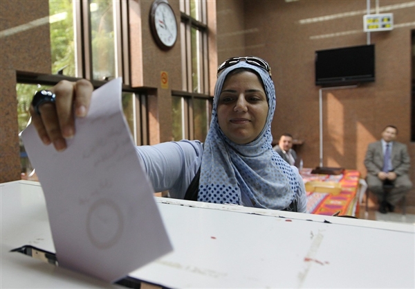 Egyptian citizen cast her vote on the draft constitution; December, 2012