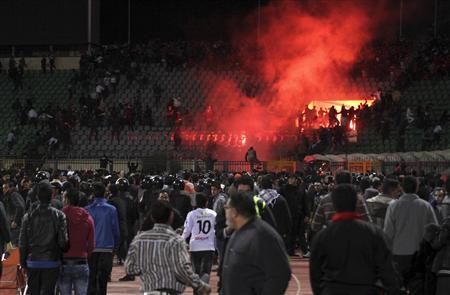 Egyptian soccer fans clash with riot police at the soccer stadium in Port Said on February 1, 2012