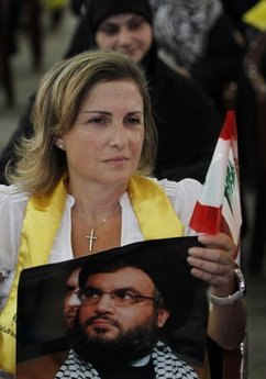 Christian woman holding Sayyed Nasrallah's picture