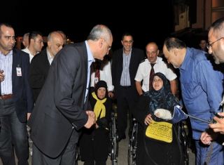 Berri's representative Ali Hassan Khalil welcoming one of the injured visitors