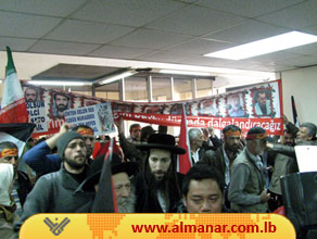 Participants in the GMJ enter into the hall of Lebanese Press Association. Photos of Turkish martyrs of Mavi Marmara killed by the Zionist enemy appear in the scene, Beirut; March 29, 2012