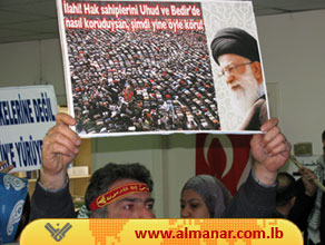 A Turkish Participant in the GMJ conference holding a banner of Grand Ayatollah Sayyed Ali Khamenie talking about the rights of the peoples