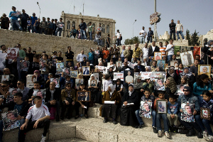 Palestinians hold portraits of relatives detained in Israeli prisons; March 24, 2012