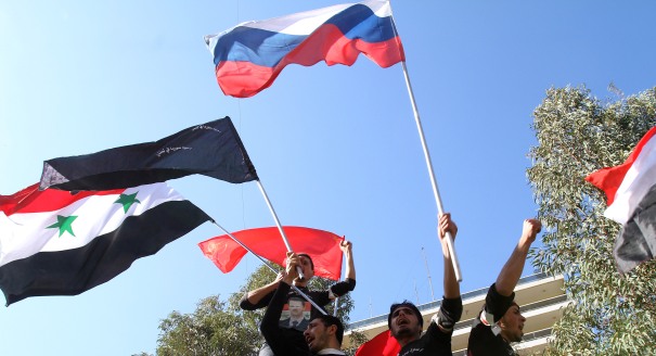 Syria: University students hold Syrian and Russian flags