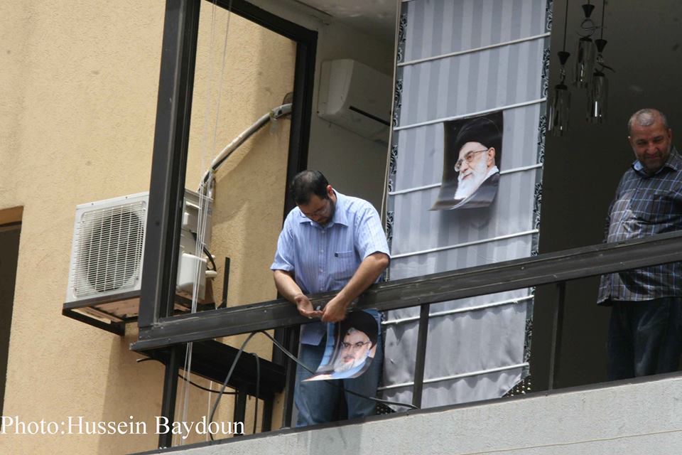 Sayyed and Imam pictures on broken window