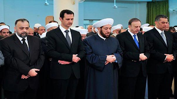 Syria’s Assad Makes Rare Public Appearance at Eid Prayers
