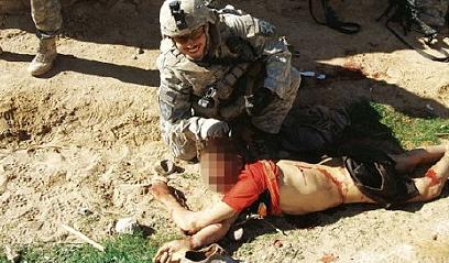 US soldiers on the boy's corpse