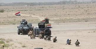 Militares iraquíes y milicias populares shiíes combaten al EI en Faluya

